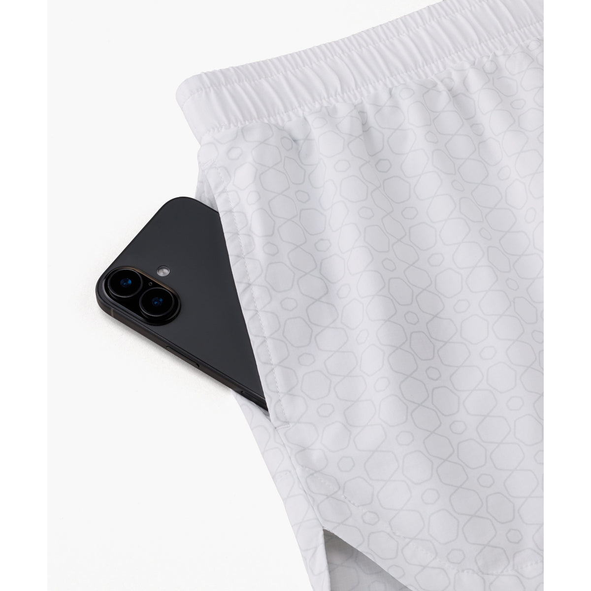 Yonex 25117 women's shorts in White - side pocket detail shown with a phone